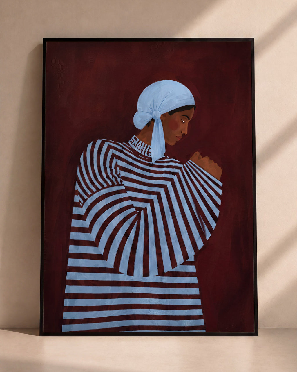 Plakat Niebieska chusta w czarnej ramie opartej o ścianę